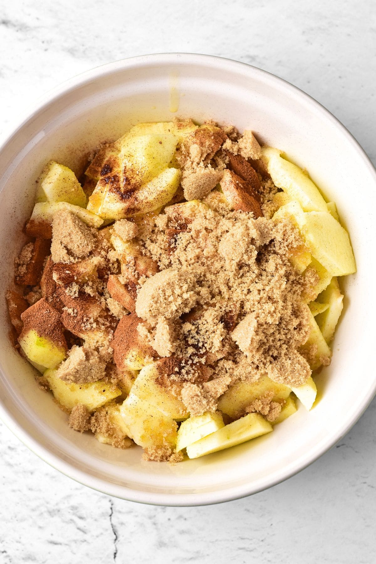 Brown sugar and cinnamon sprinkled on top of sliced apples