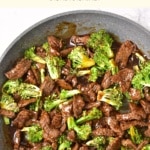 Top down view of broccoli beef in a skillet.
