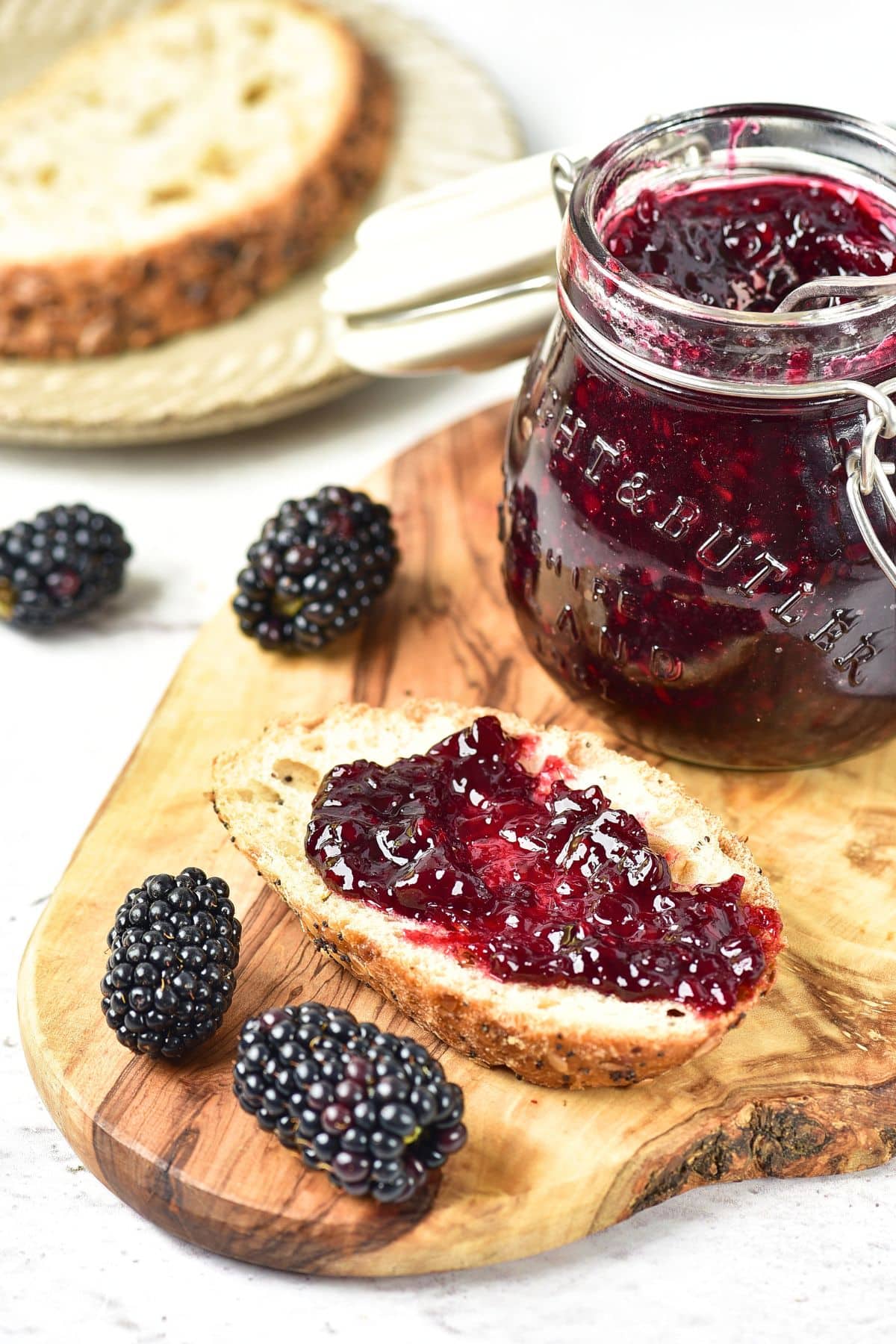 A slice of toast spread with blackberry jam without pectin.