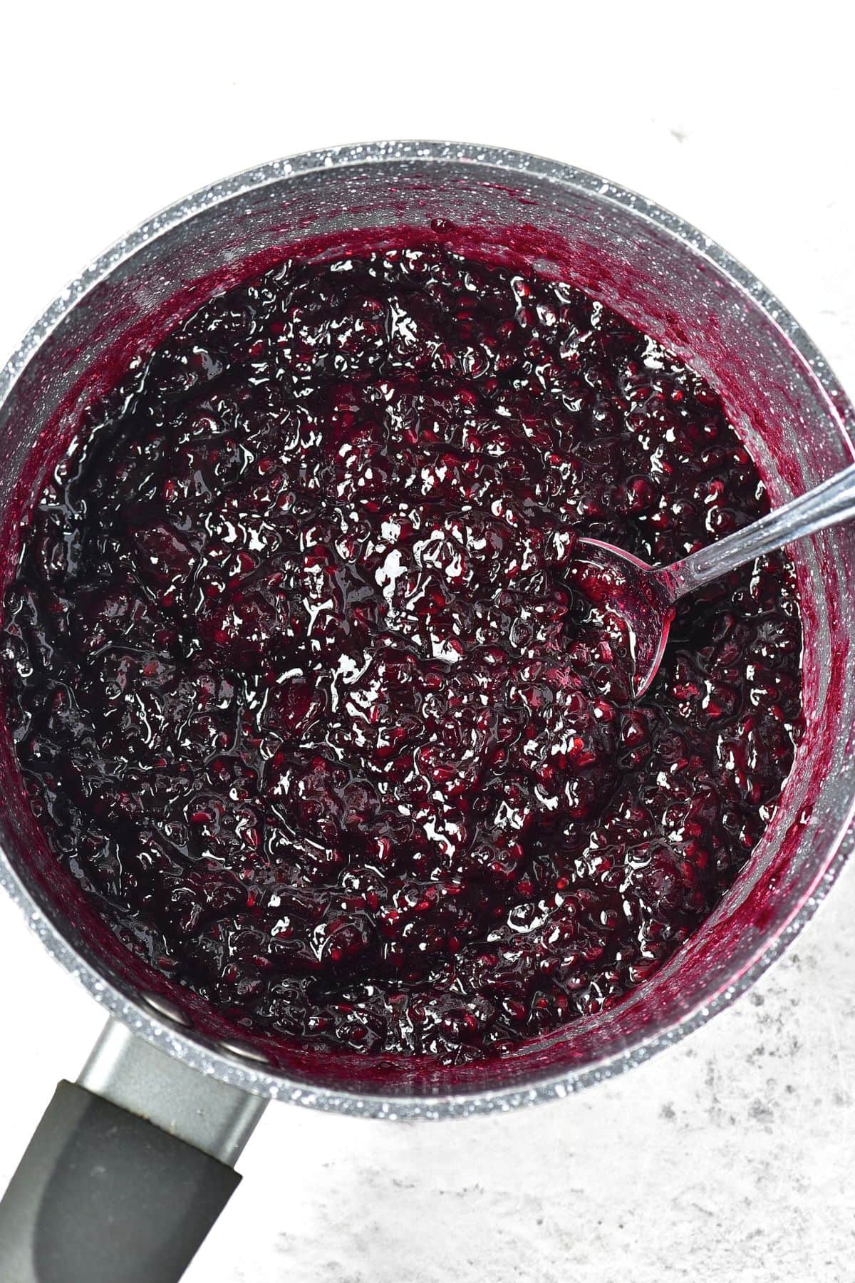 Top down view of blackberry preserves in saucepan