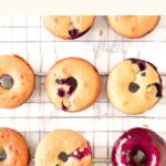Blueberry glazed donuts cooling on wire rack