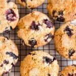 Pinterest image of blueberry muffins cooling on wire rack.