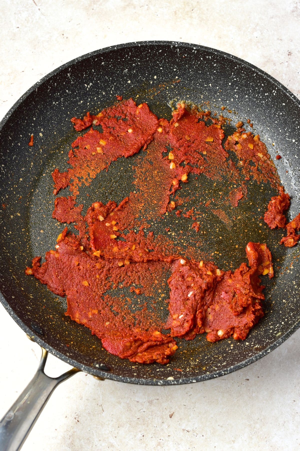 Sautéing tomato paste in skillet