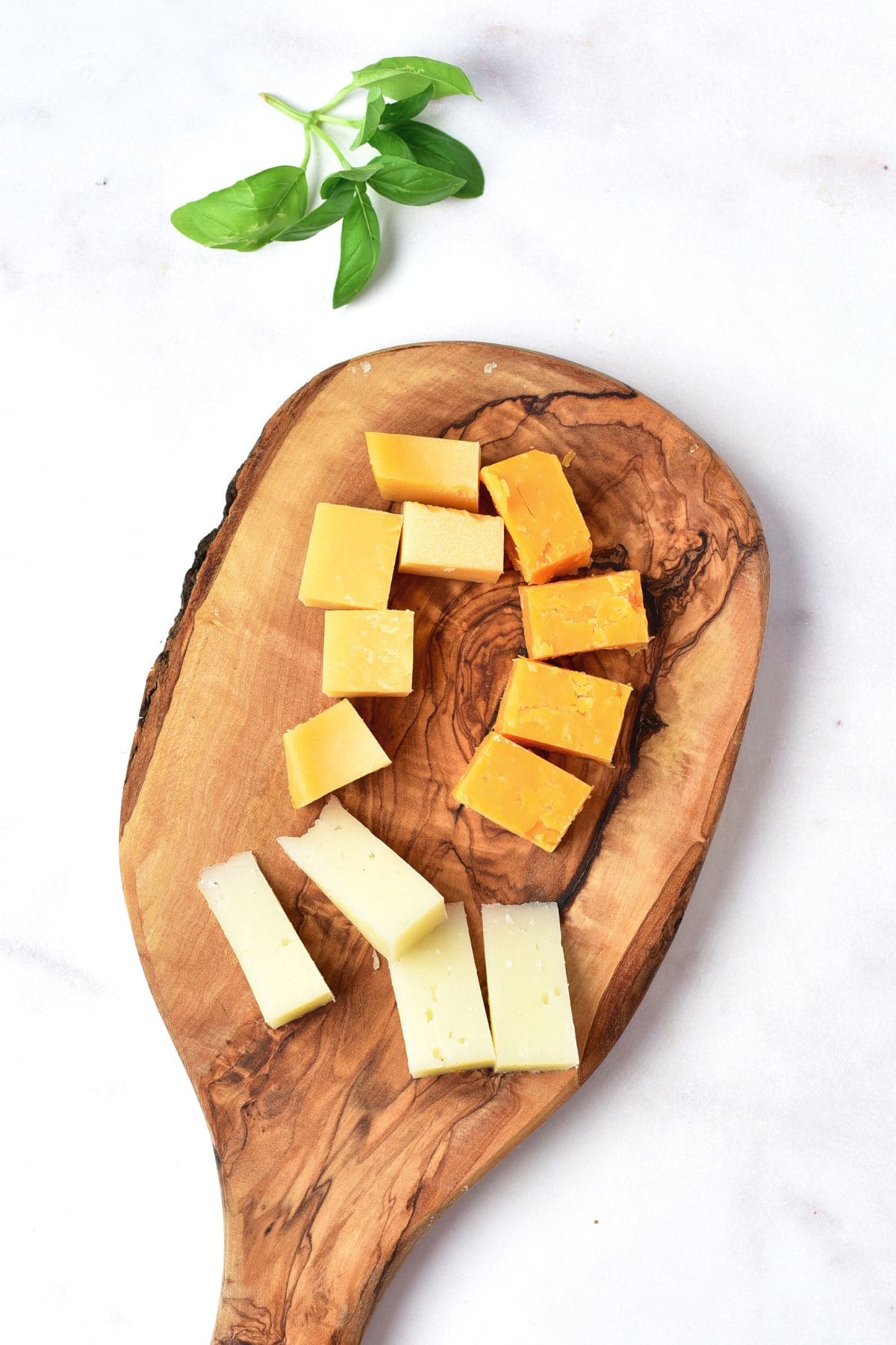 Cheese cubes on wooden board.