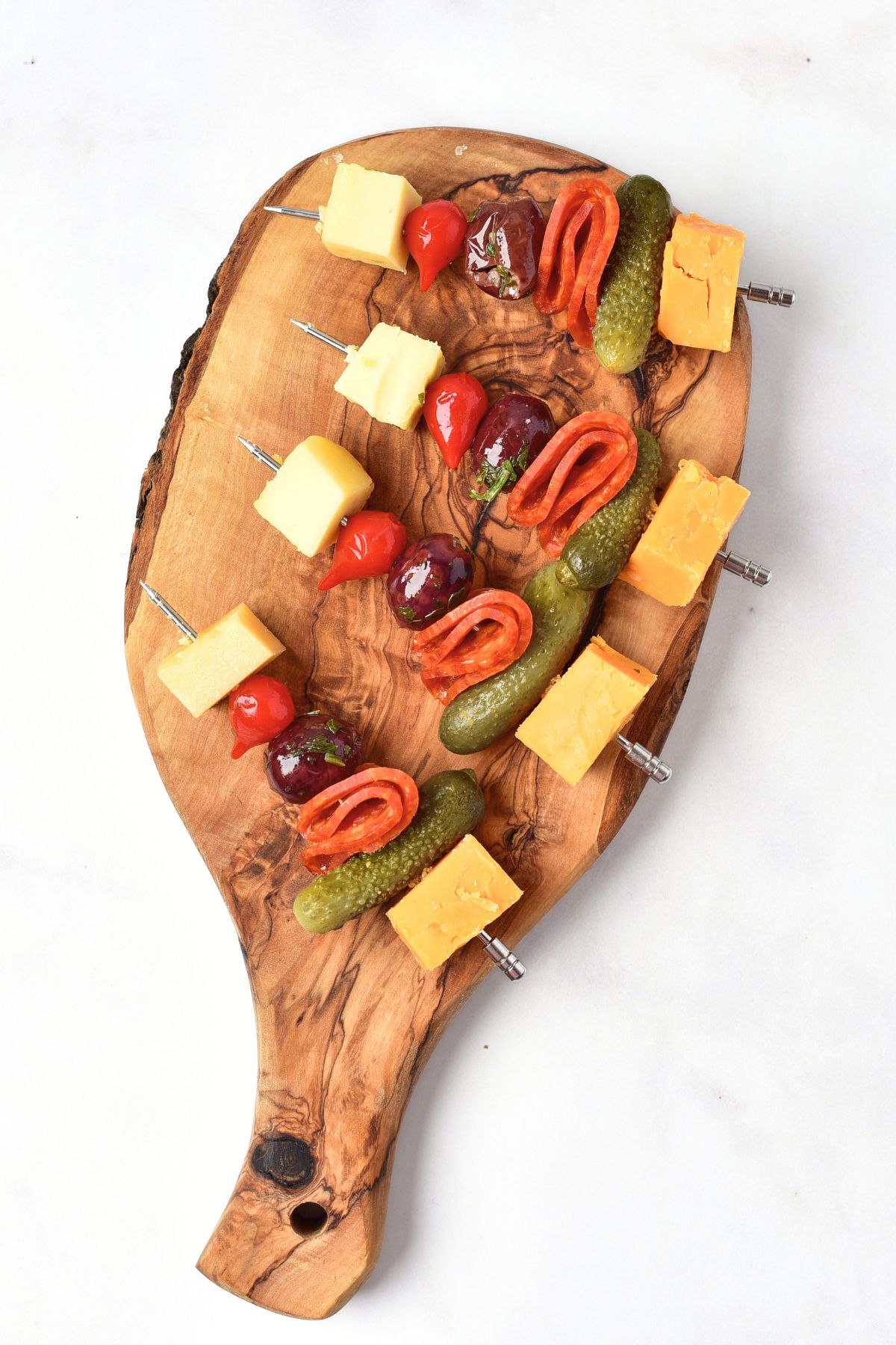 Appetizer kabobs on wooden board