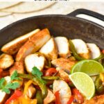 A skillet with chicken fajitas and lime wedges