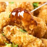 Holding up a chicken nugget with a toothpick