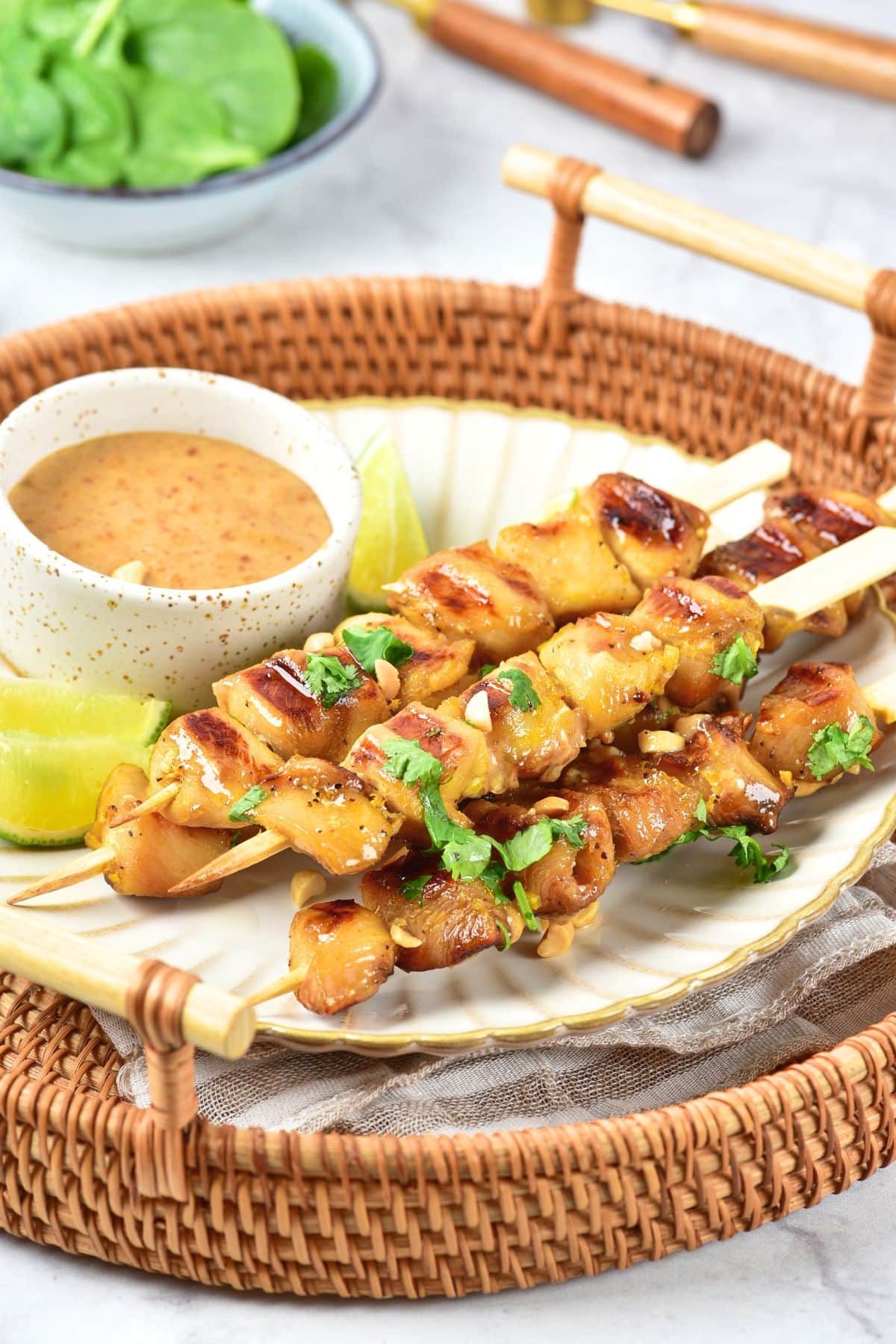 A plate of gluten-free chicken stay on bamboo tray.