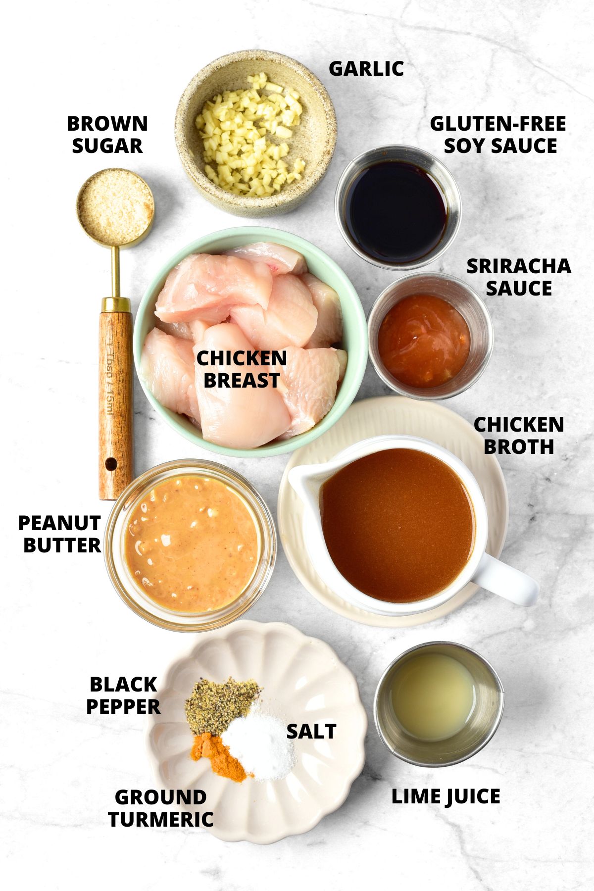 Ingredients for gluten-free chicken satay recipe laid out on marble board.