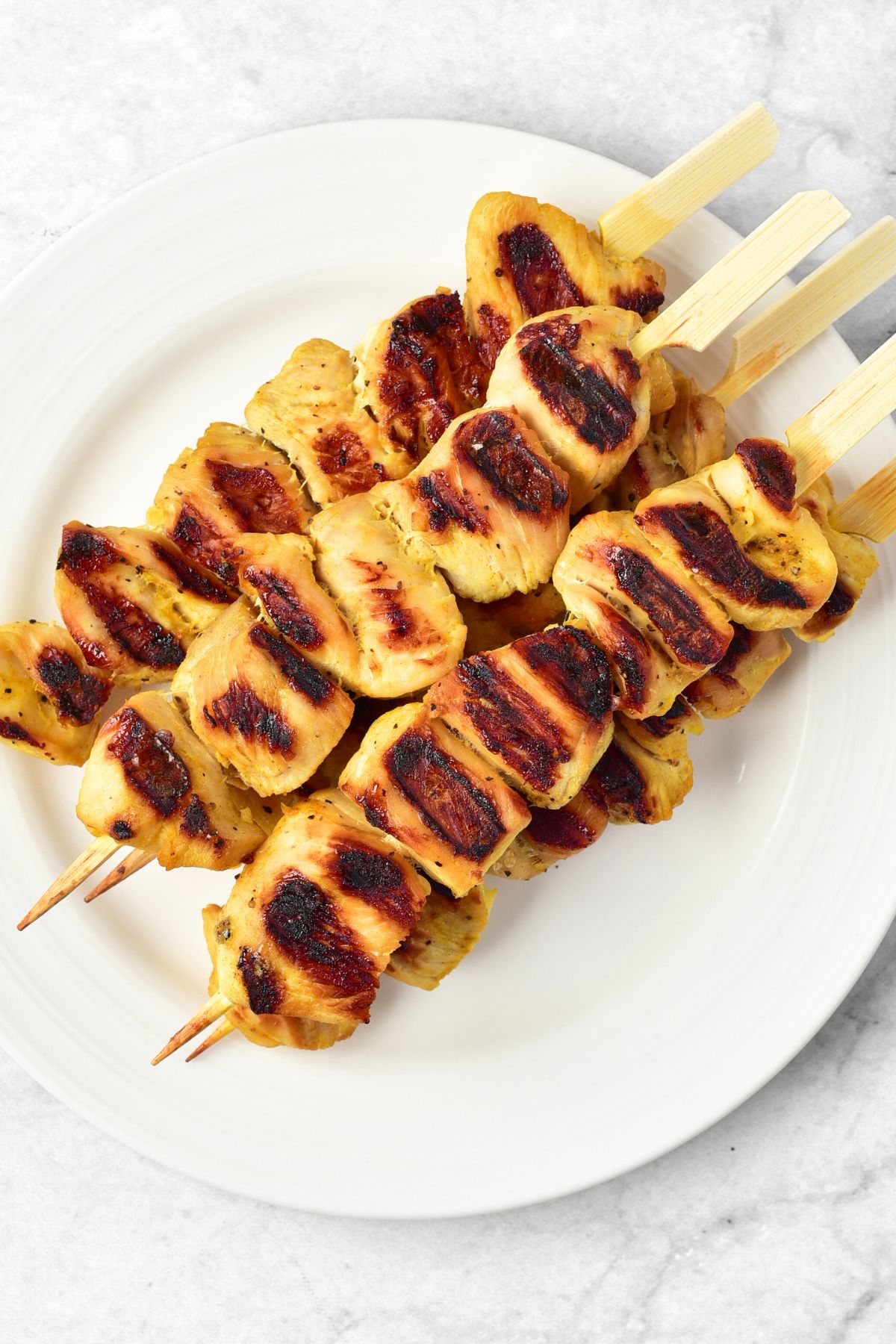 Freshly grilled chicken skewers on plate