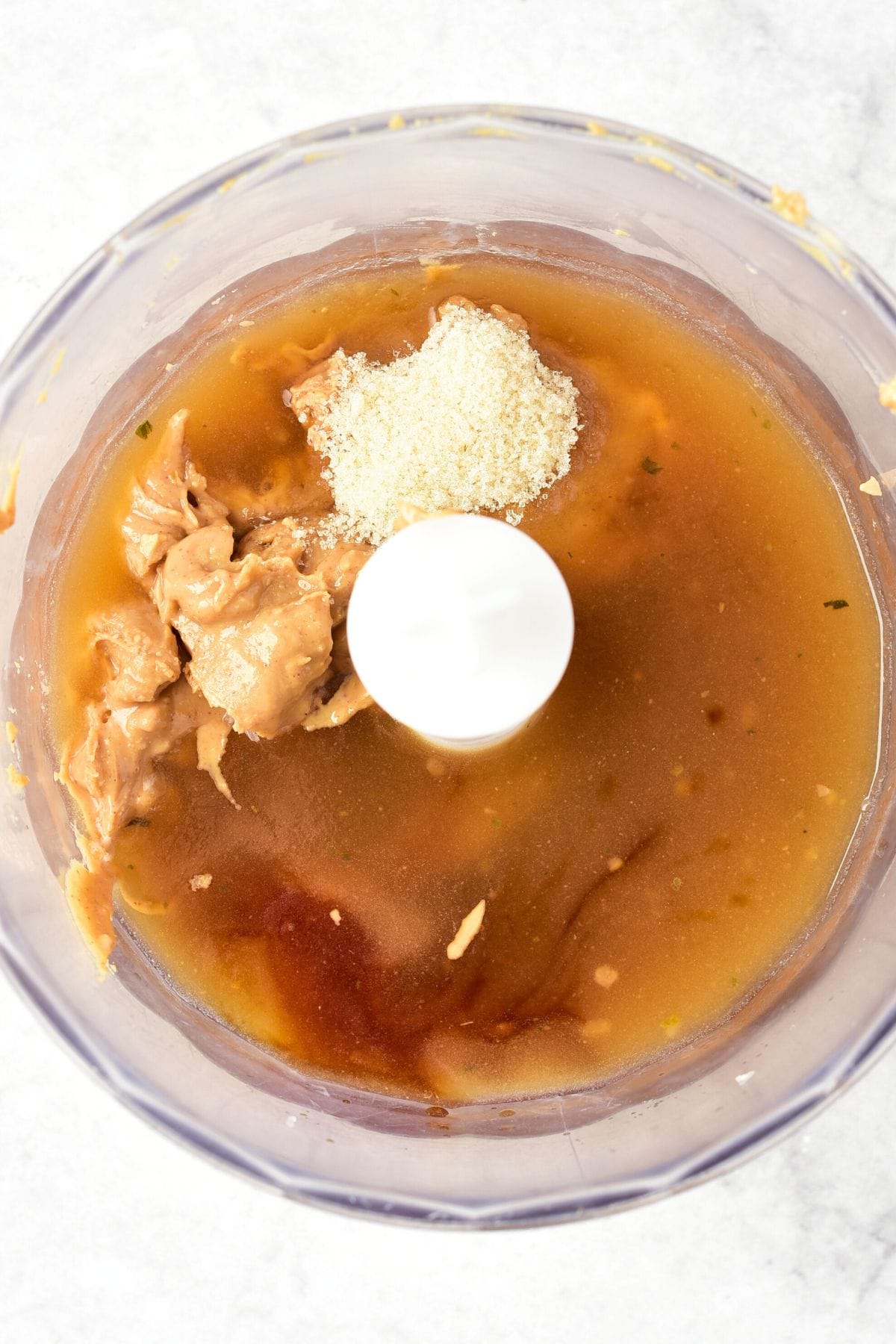 Peanut butter, chicken broth, brown sugar, in food processor.