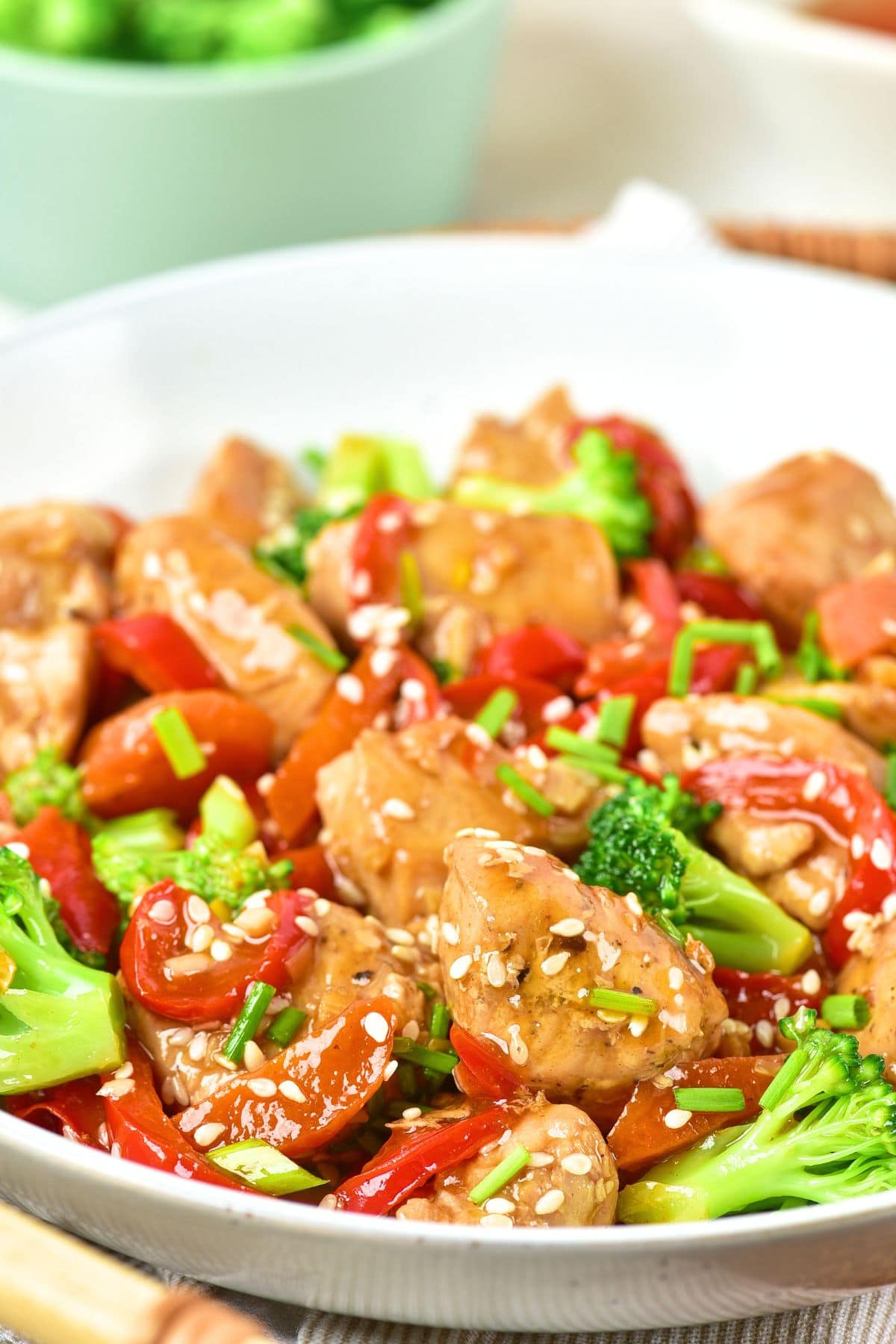Up close view of a bowl of stir fry chicken and vegetables