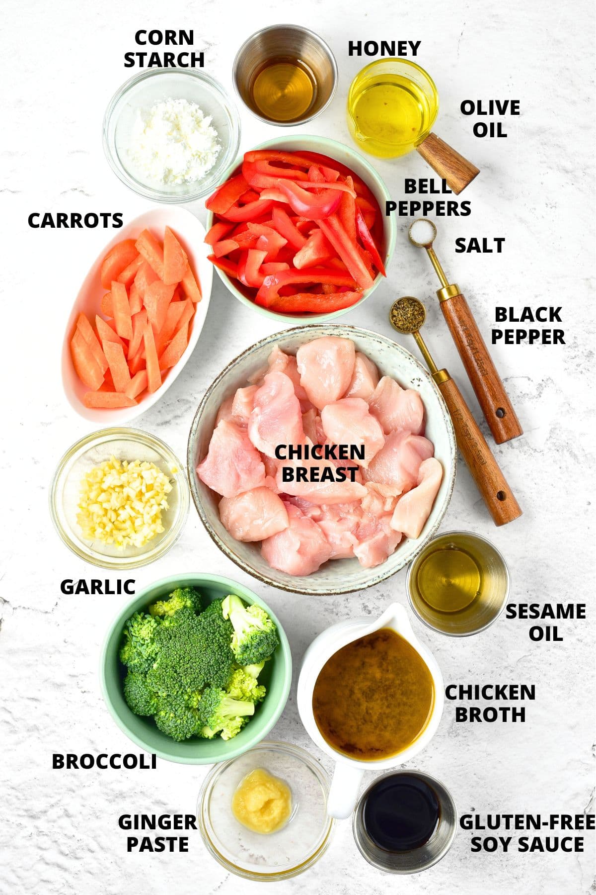 Ingredients for gluten-free chicken stir fry recipe laid on on marble board.