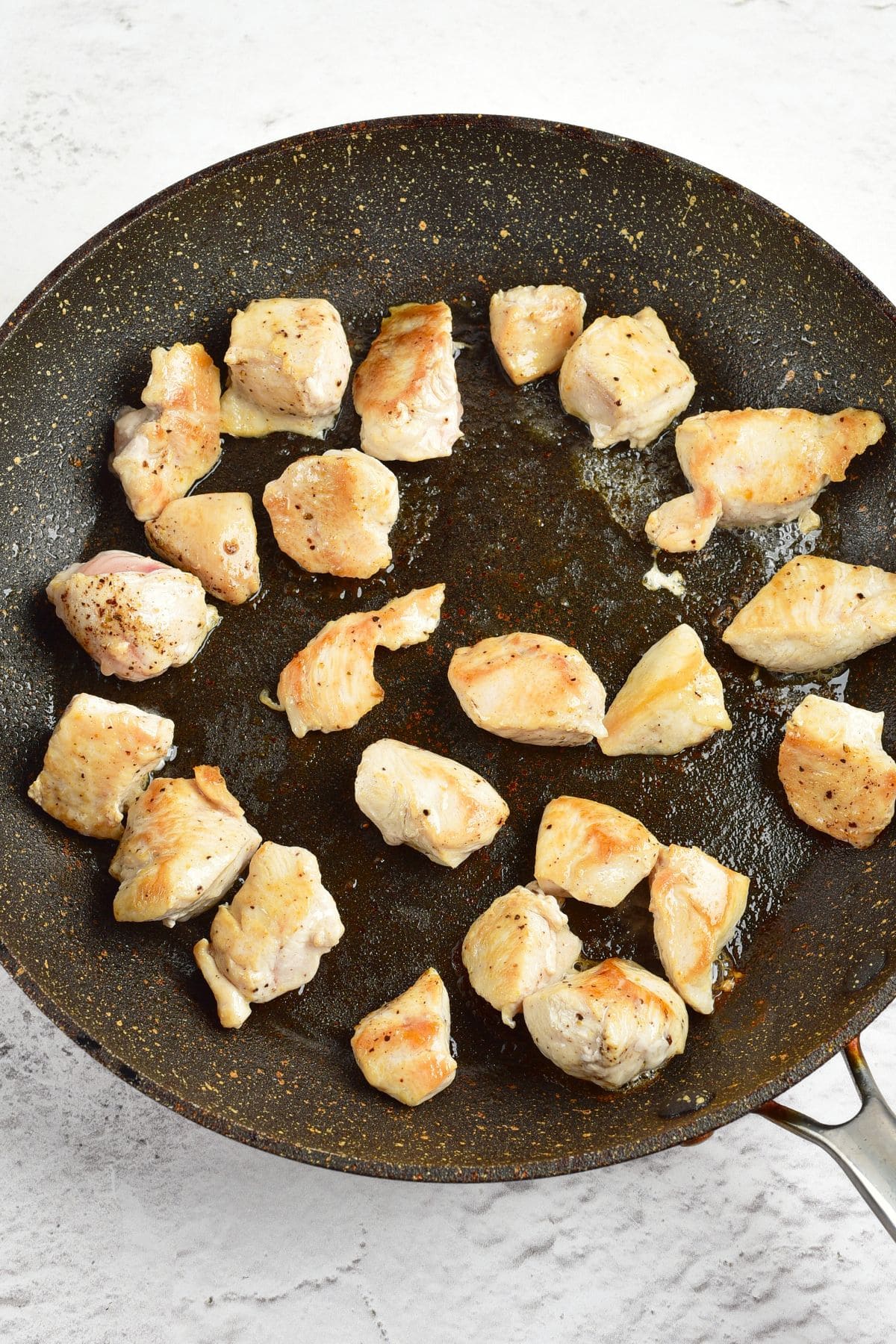 Stir frying chicken cubes in skillet