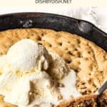Half-eaten skillet cookie topped with ice cream.