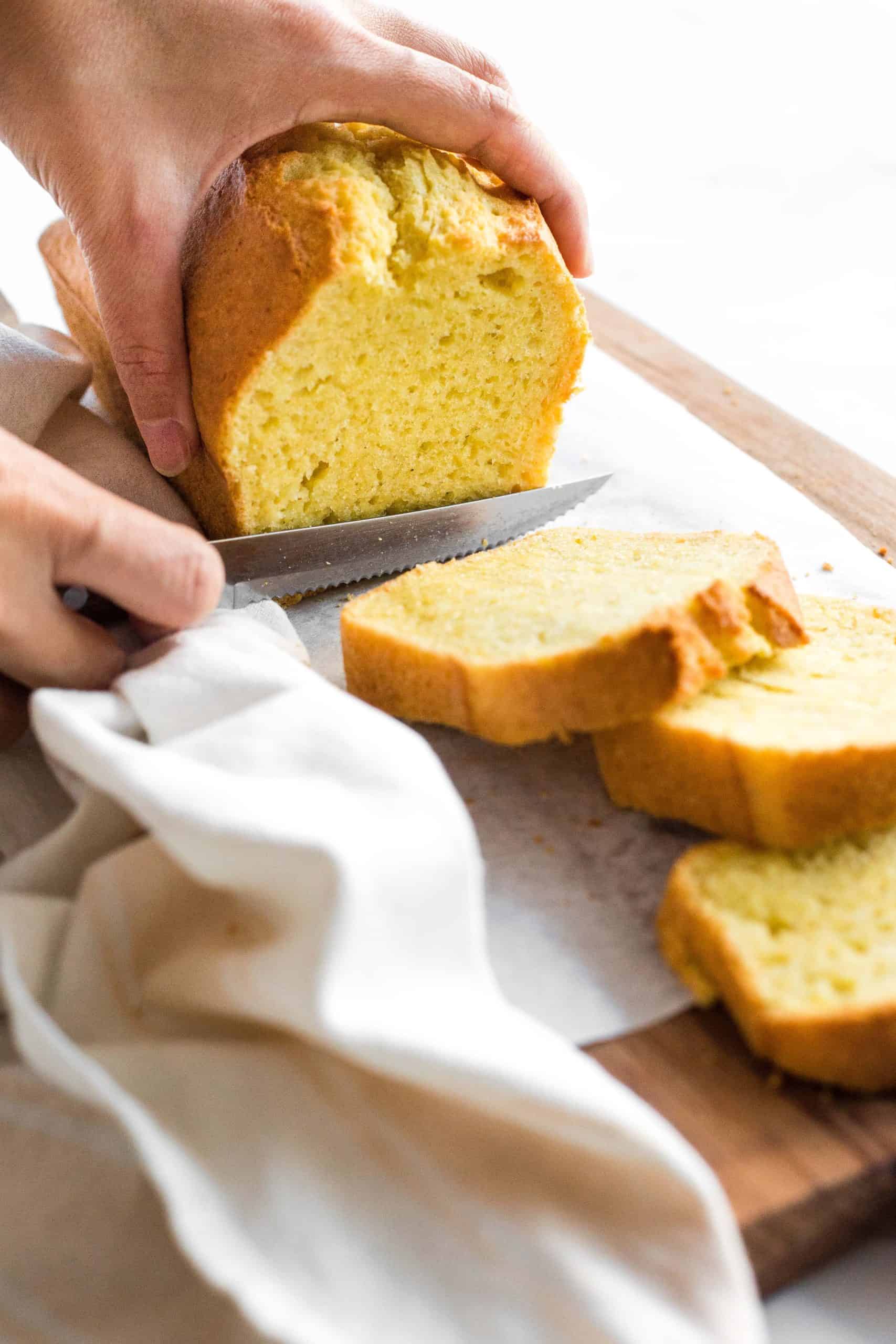 Slicing into a loaf of corn bread.