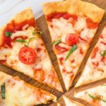 Pizza slices on wooden board