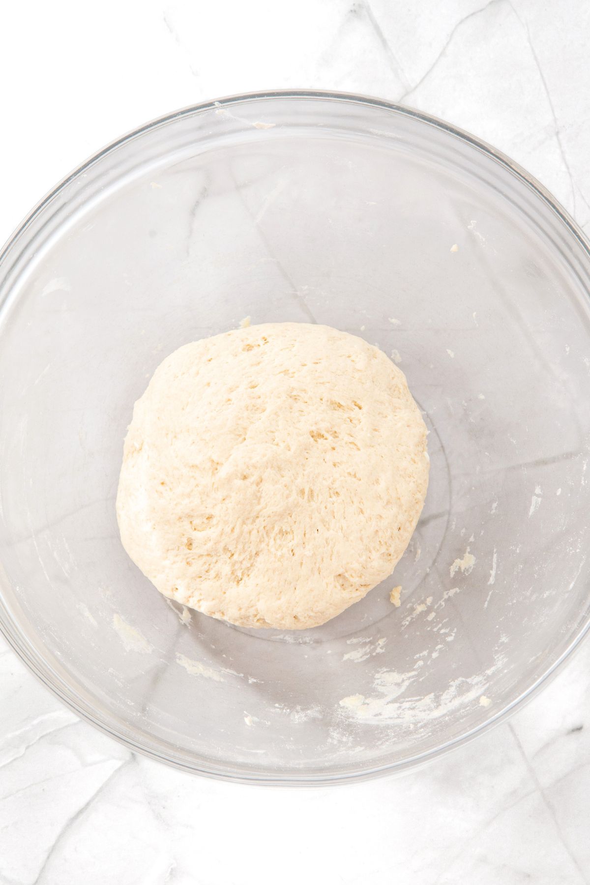 Pizza dough in glass bowl