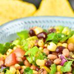 A bowl of cowboy caviar with tortilla chips