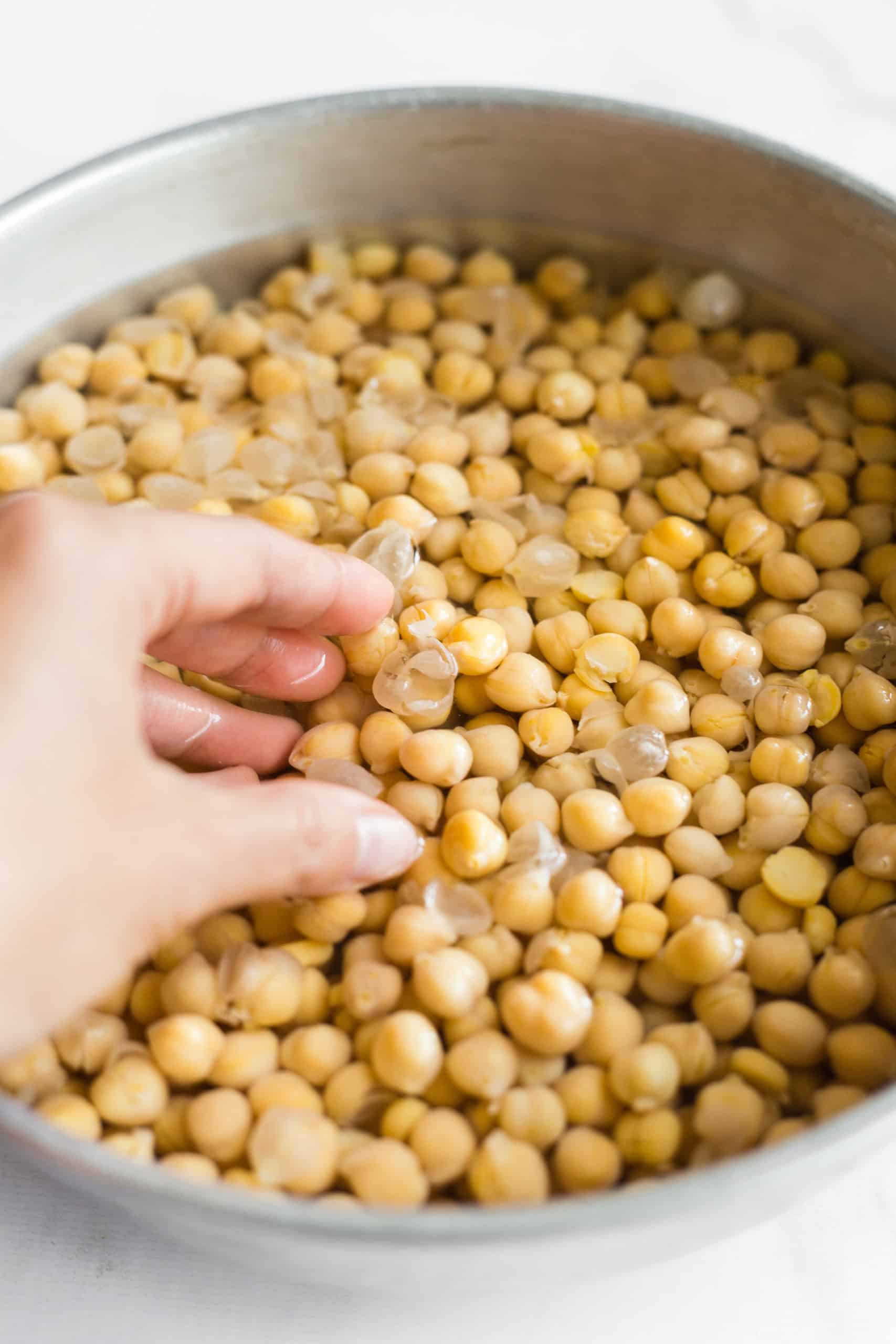 Soaking the cooked chickpeas in hot water and baking soda to get the skins to come off.