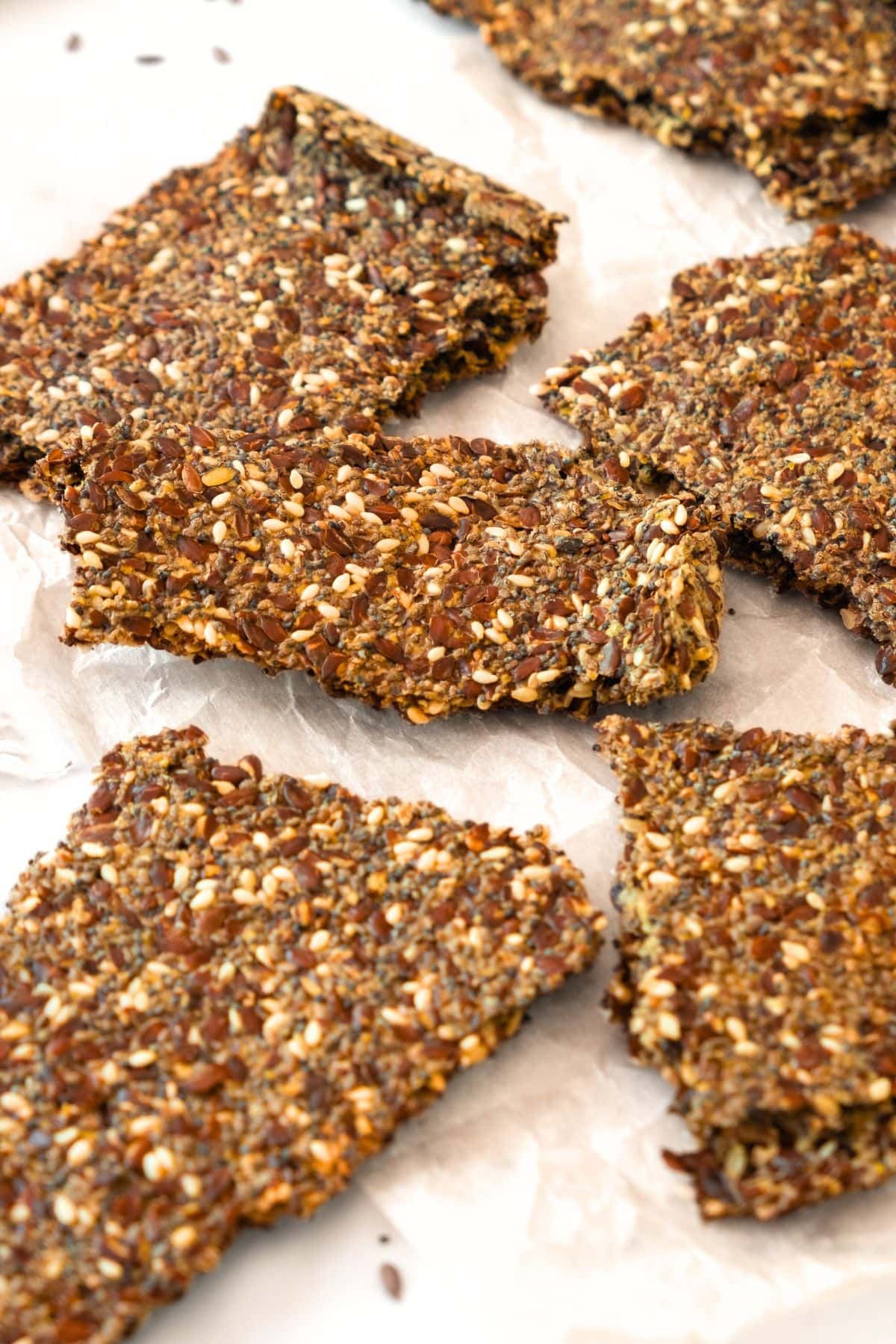 Homemade flaxseed meal crackers on parchment paper.