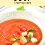 A bowl of gazpacho soup topped with croutons