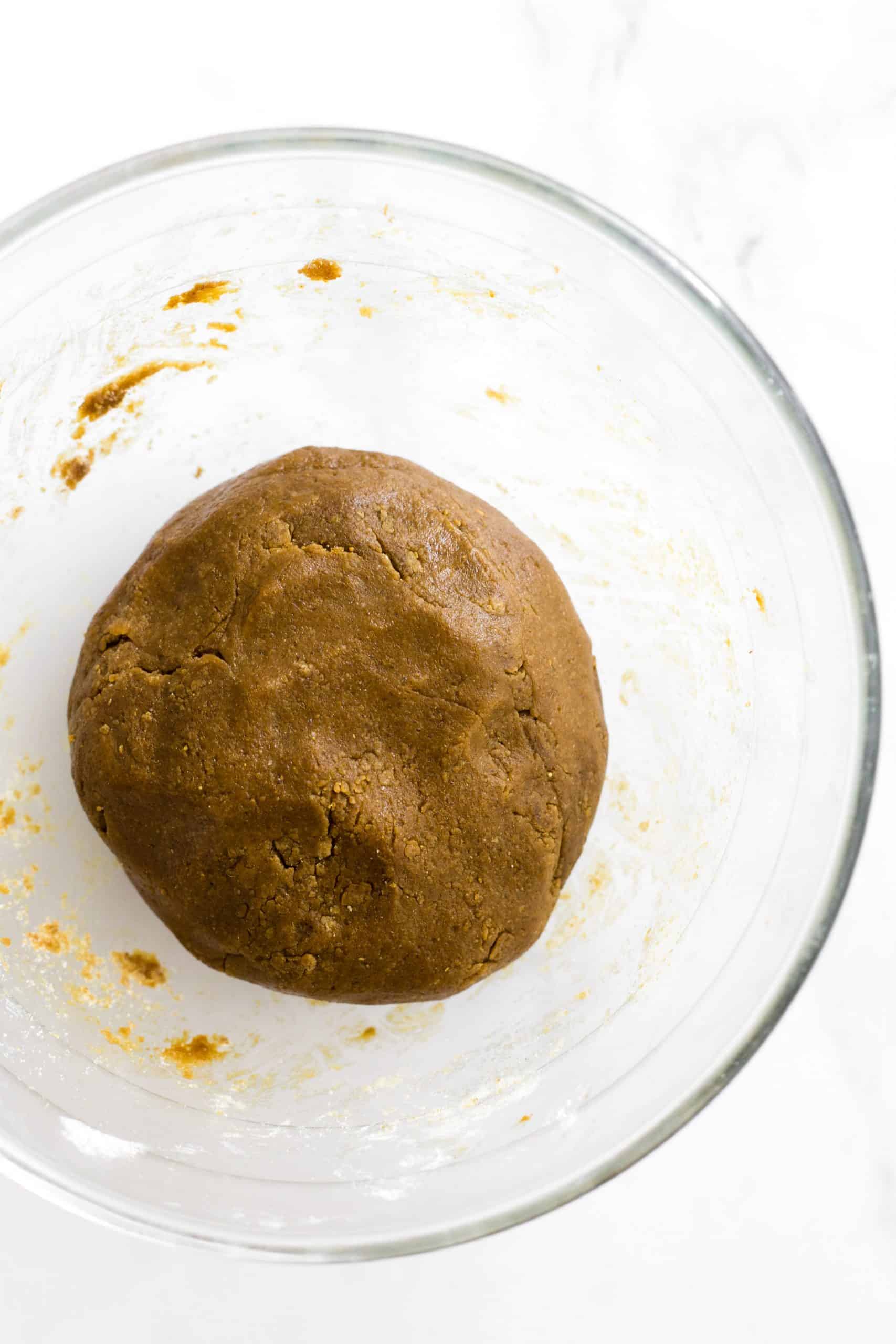 Gluten-free gingerbread dough in a mixing bowl.