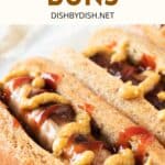 Up close shot of hot dogs topped with mustard and ketchup.