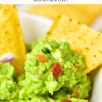 Up close view of tortilla chips dipped in homemade guacamole