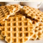 A plate of gluten-free waffles on wooden board.