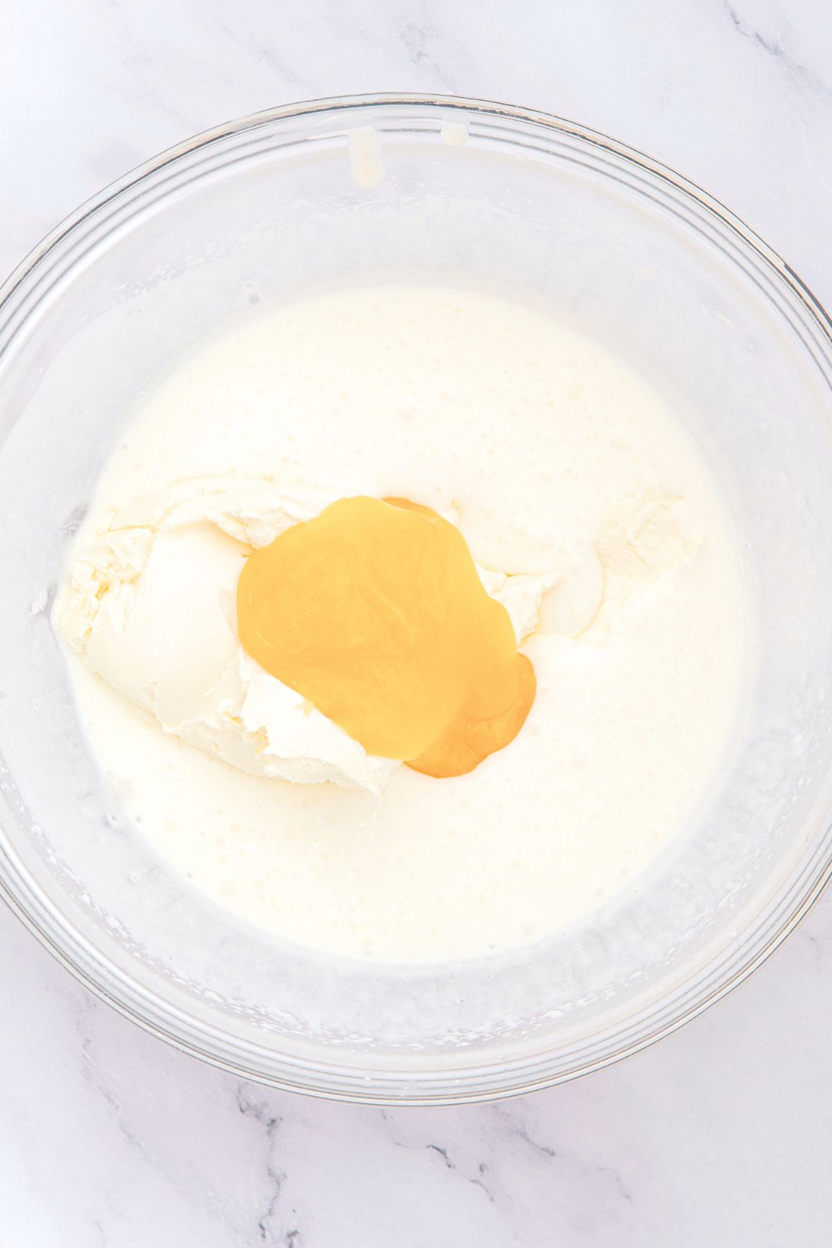 Lemon curd on top of whipped cream