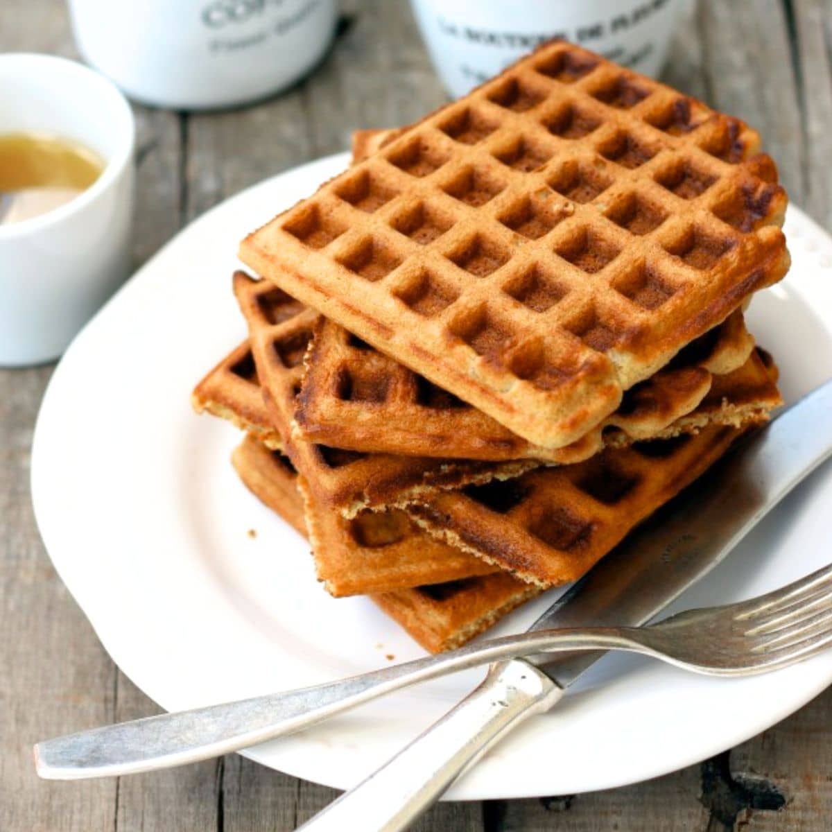 Up close shot of a stack of oat flour waffles.