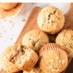 Top down view of oatmeal muffins on wooden board.