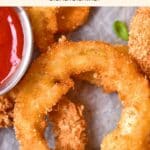 Up close view of crispy onion ring on parchment paper.