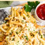Top down view of parmesan and truffle fries on parchment lined board