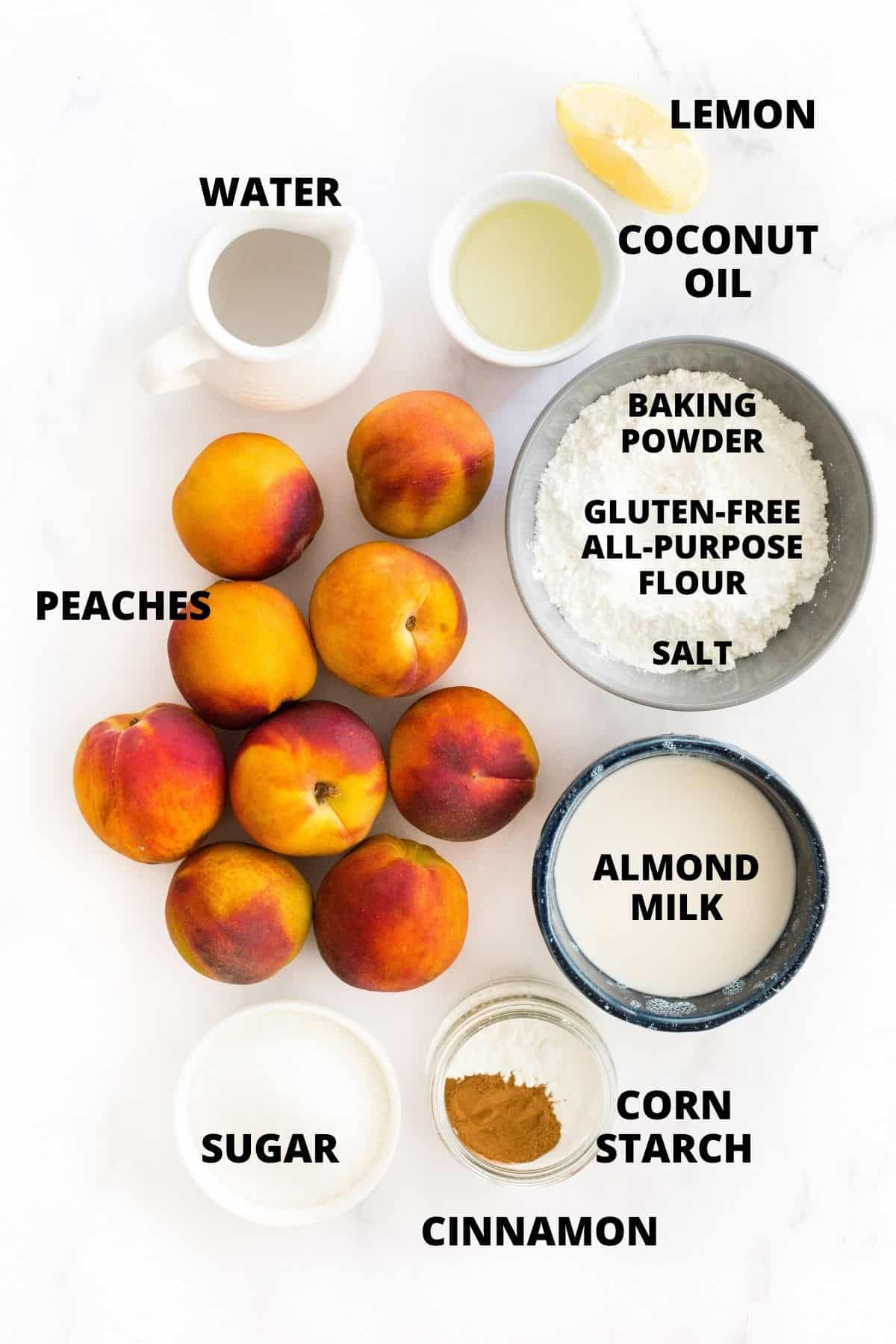 Ingredients for making gluten-free peach cobbler recipe laid out on marble board.