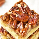 A stack of gluten-free pecan pie bars.