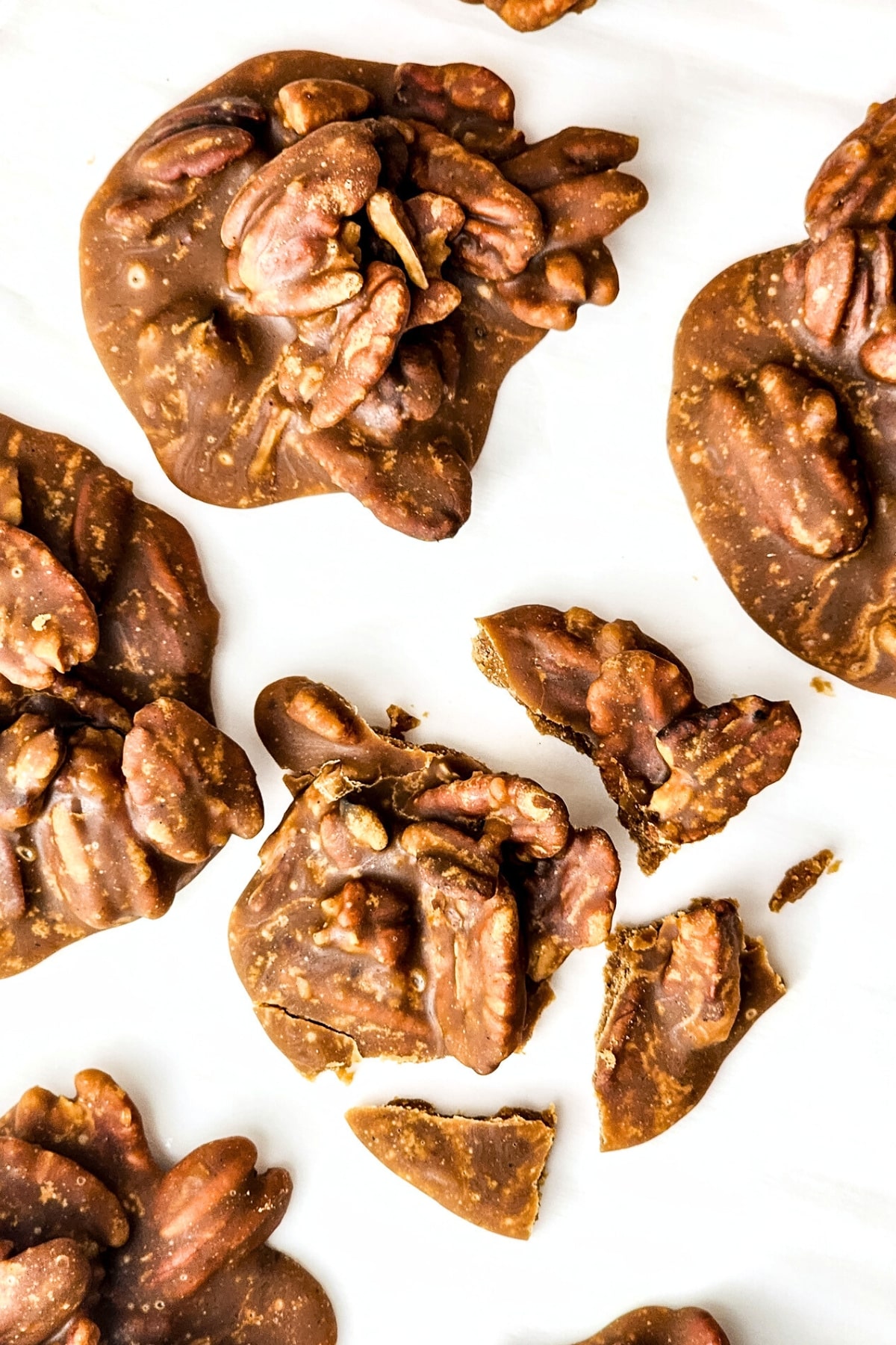 Top down view of pecan pralines on parchment paper.