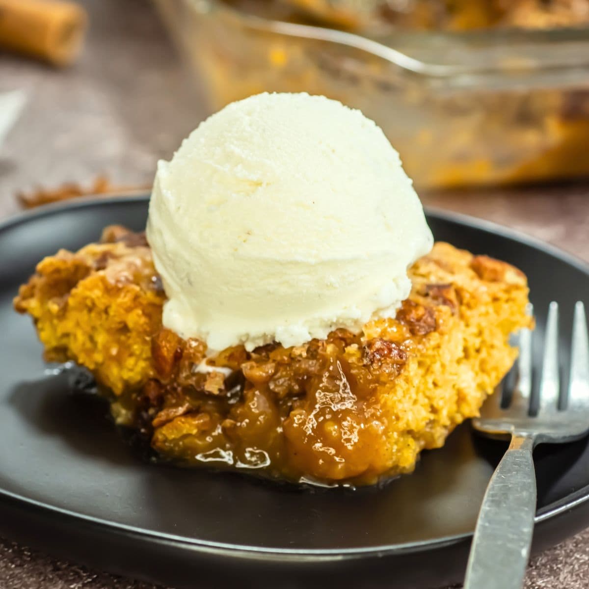 A scoop of ice cream over pumpkin cobbler