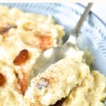 Holding up a spoonful of dairy free rice pudding from a bowl.