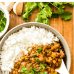 Slow cooker lentil curry in a bowl on a wooden board