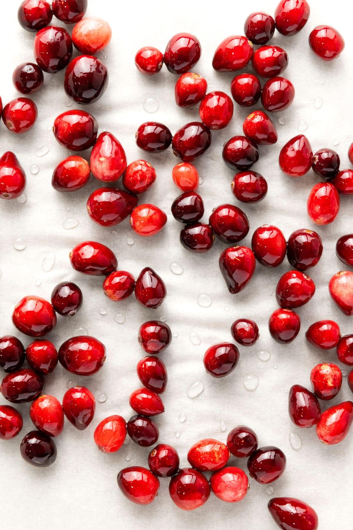 Syrup coated cranberries on parchment paper