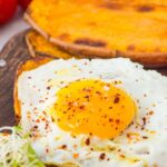Up close shot of a sweet potato toast topped with egg
