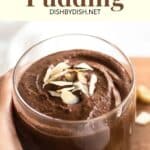 Hand holding a cup of vegan chocolate pudding.