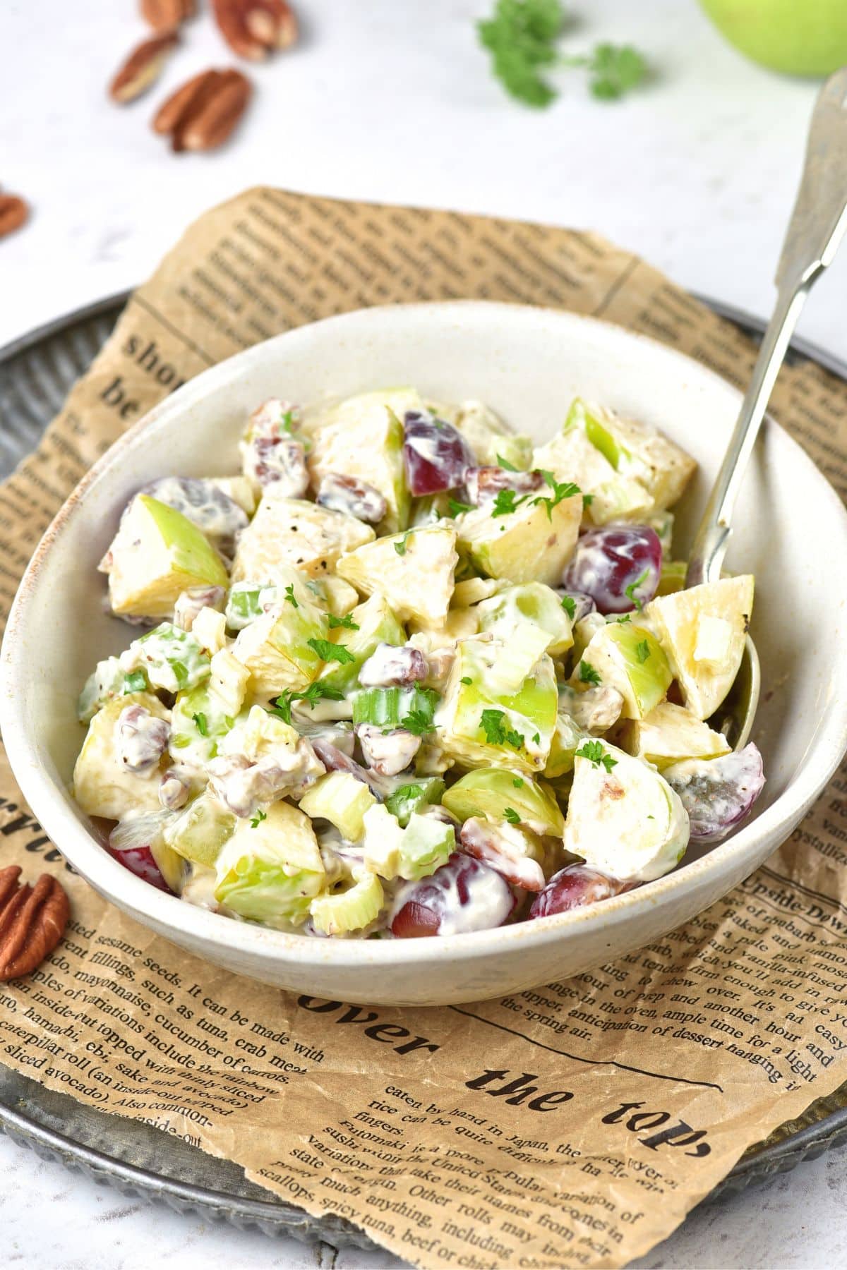 A bowl of vegan waldorf salad with grapes, chicken and celery
