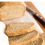 Slices of gluten-free whole grain bread on wooden board.