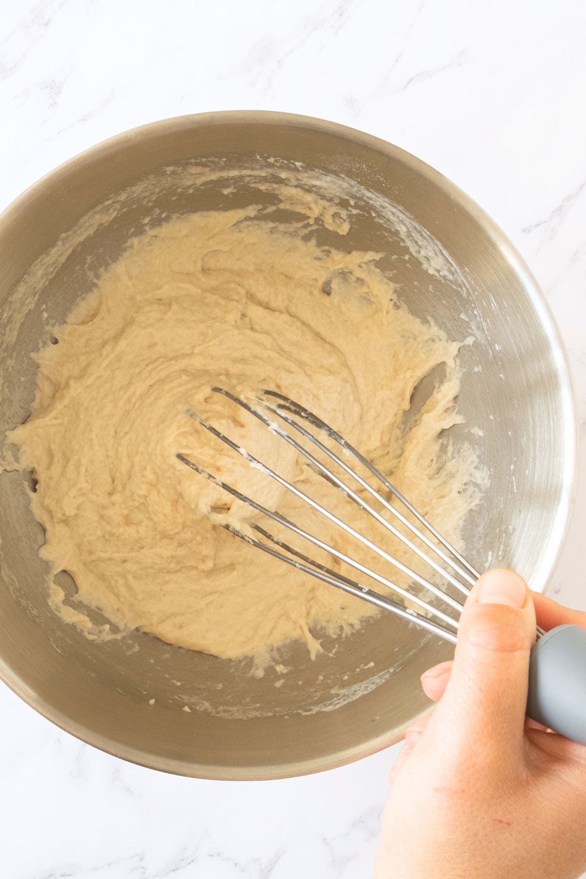 Mixing gluten-free bread dough with whisk.