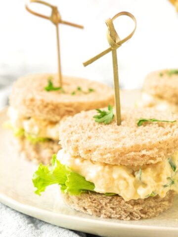 Mini egg salad tea sandwiches on plate