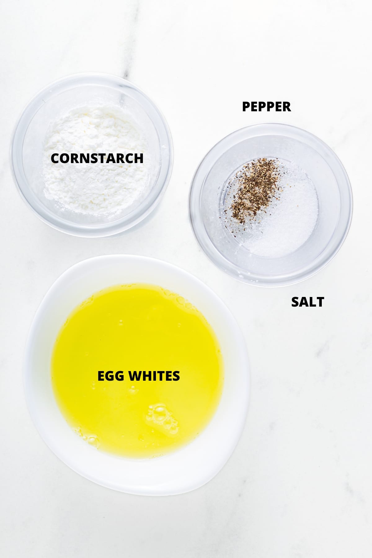 Top down view of ingredients for egg white tortilla recipe on marble board.
