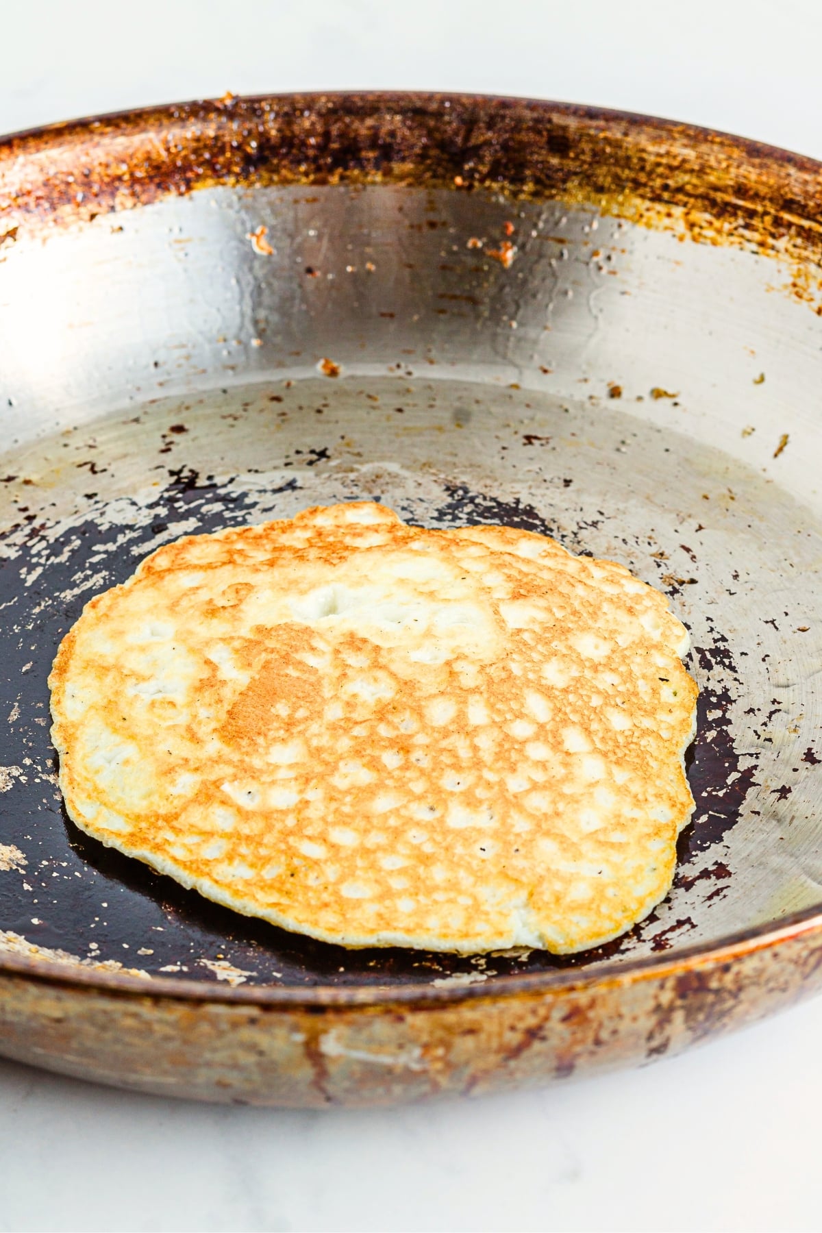 Cooked egg white tortilla in skillet